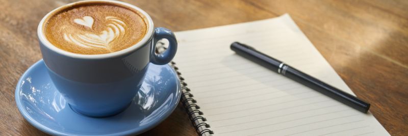 Cup of coffee and note book